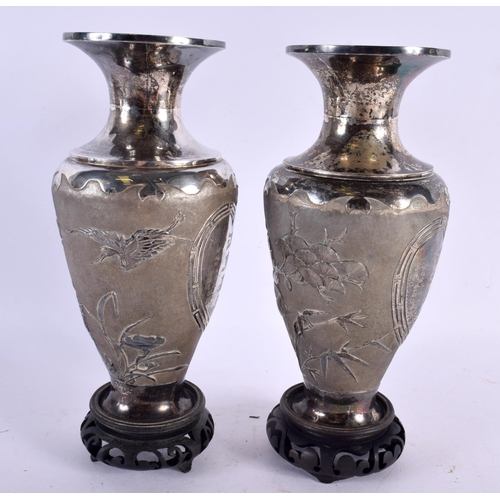 2319 - A PAIR OF 19TH CENTURY CHINESE EXPORT SILVER VASES decorated in relief with birds and landscapes. Si... 