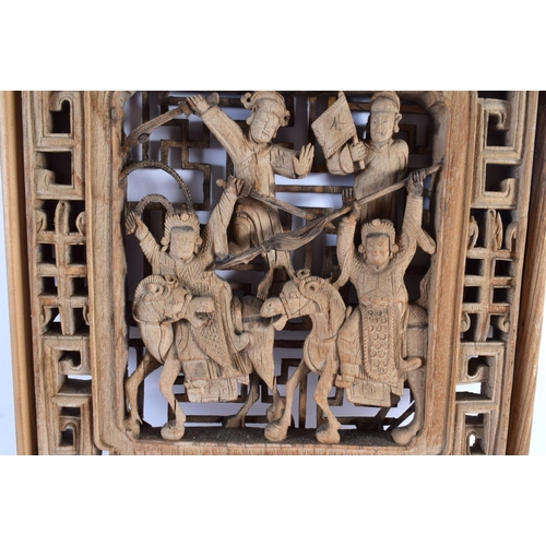 2320 - A CHINESE QING DYNASTY CARVED HARDWOOD TEMPLE PANEL depicting figures fighting. 55 cm x 25 cm.