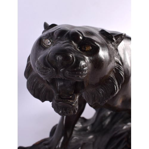 2371 - A LARGE 19TH CENTURY JAPANESE MEIJI PERIOD BRONZE OKIMONO modelled as a roaming tiger, with glass ey... 