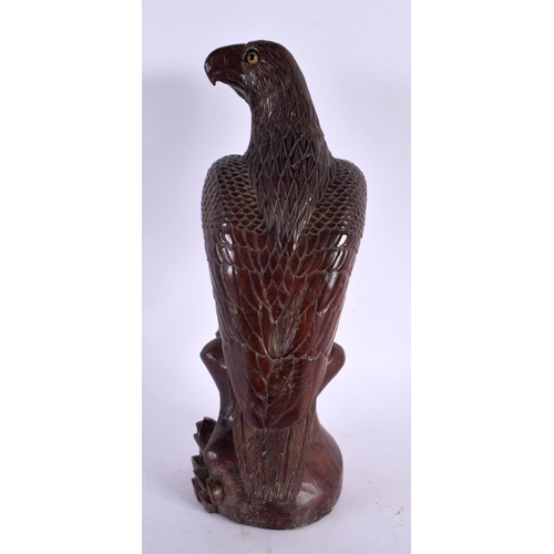 2390 - A 19TH CENTURY JAPANESE MEIJI PERIOD CARVED WOOD HAWK modelled upon a naturalistic base. 30 cm high.