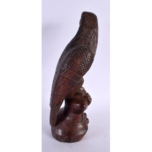 2390 - A 19TH CENTURY JAPANESE MEIJI PERIOD CARVED WOOD HAWK modelled upon a naturalistic base. 30 cm high.