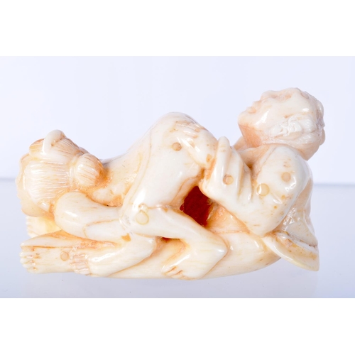 1381 - A CARVED BONE EROTIC NETSUKE.  5.5cm x 3.1cm x 2.9cm