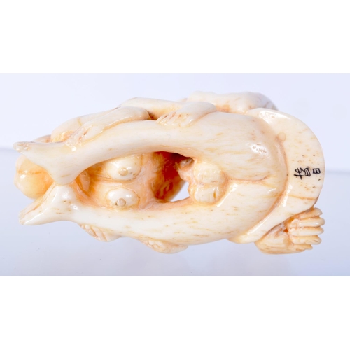 1381 - A CARVED BONE EROTIC NETSUKE.  5.5cm x 3.1cm x 2.9cm