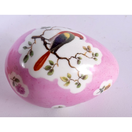 1 - A 19TH CENTURY CONTINENTAL PORCELAIN PINK GROUND EGG painted with birds perched amongst landscapes. ... 