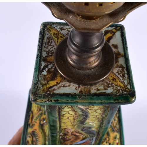 101 - AN EARLY 20TH CENTURY ITALIAN POTTERY SQUARE FORM LAMP decorated with animals and dragons in landsca... 