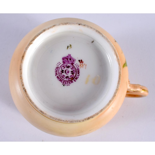 127 - A ROYAL WORCESTER BLUSH IVORY MOUSTACHE CUP AND SAUCER painted with flowers. 14cm diameter. (2)