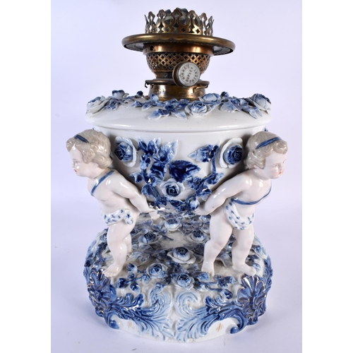 129 - AN UNUSUAL LARGE 19TH CENTURY GERMAN SITZENDORF PORCELAIN OIL LAMP formed with three putti holding a... 