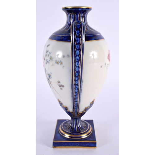 145 - A ROYAL WORCESTER TWIN HANDLED PORCELAIN VASE painted with flowers. 18cm high.