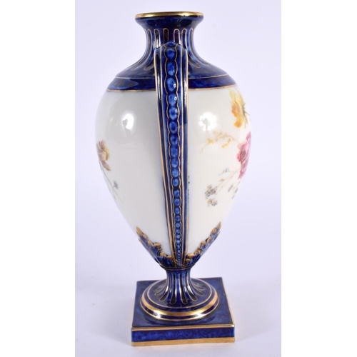 145 - A ROYAL WORCESTER TWIN HANDLED PORCELAIN VASE painted with flowers. 18cm high.