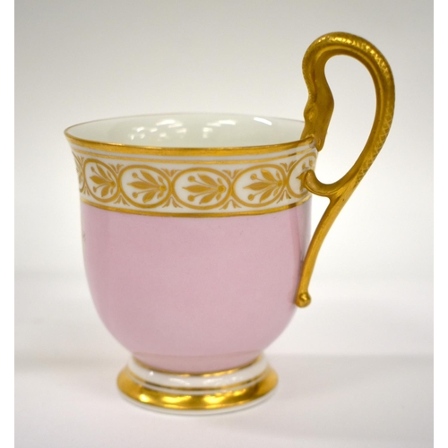 163 - Early 19th century Berlin coffee cup and saucer, with snake handle, the pink ground with gilt oval p... 