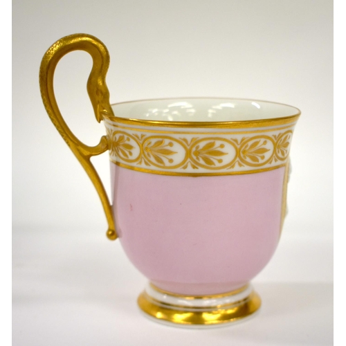 163 - Early 19th century Berlin coffee cup and saucer, with snake handle, the pink ground with gilt oval p... 