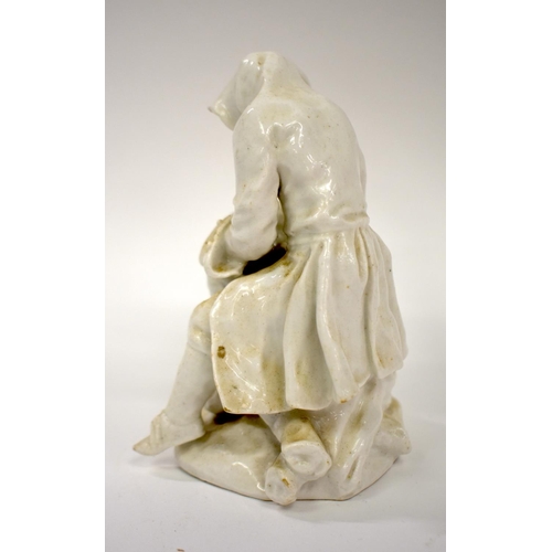 165 - 18th century Bow white glazed figure winter of seated on a pile of logs.  12.5cm high