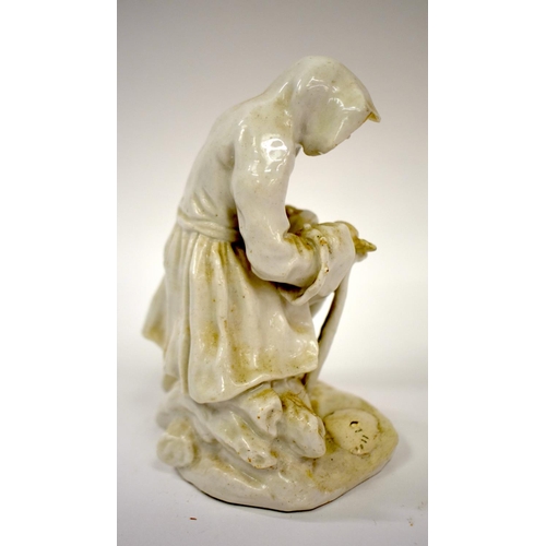 165 - 18th century Bow white glazed figure winter of seated on a pile of logs.  12.5cm high