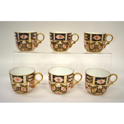 216 - Royal Crown Derby set of six coffee cans and saucers, painted with imari pattern 2451, having ornate... 