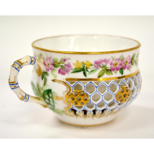 256 - 19th century Royal Worcester reticulated cup and saucer painted with flowers, a bird and an insect, ... 