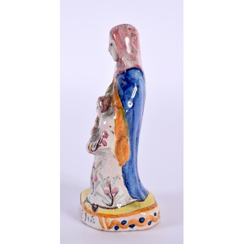 26 - AN ANTIQUE FRENCH FAIENCE TIN GLAZED POTTERY FIGURE OF ST ANNE. 9.5 cm high.