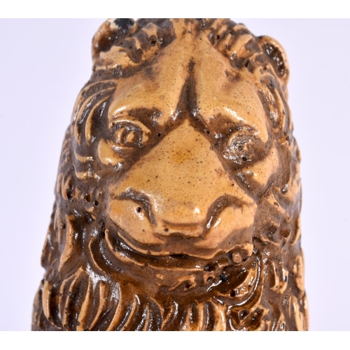 27 - AN UNUSUAL 18TH CENTURY FRENCH SALT GLAZED POTTERY FIGURE OF A LION modelled holding a fleur de lys ... 