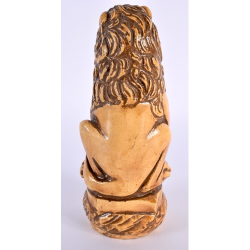 27 - AN UNUSUAL 18TH CENTURY FRENCH SALT GLAZED POTTERY FIGURE OF A LION modelled holding a fleur de lys ... 