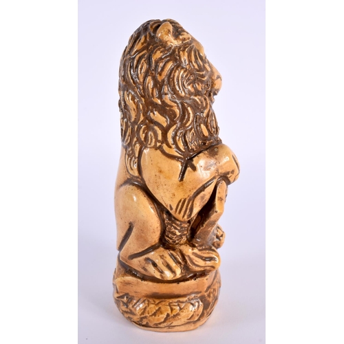 27 - AN UNUSUAL 18TH CENTURY FRENCH SALT GLAZED POTTERY FIGURE OF A LION modelled holding a fleur de lys ... 