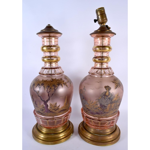 30 - A LARGE PAIR OF 19TH CENTURY BOHEMIAN GLASS LAMPS painted with figures in landscapes. 46 cm high.