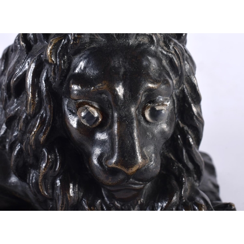 312 - A LOVELY EARLY 19TH CENTURY REGENCY BRONZE MODEL OF A recumbent LION modelled upon a naturalistic ba... 