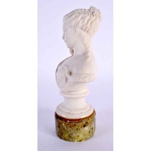 32 - AN EARLY 20TH CENTURY PARIAN WARE BUST OF A FEMALE modelled with a bird on her shoulder. 15cm high.