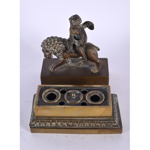 335 - A LOVELY EARLY 19TH CENTURY ENGLISH REGENCY BRONZE INKWELL depicting a winged boy riding upon a lion... 