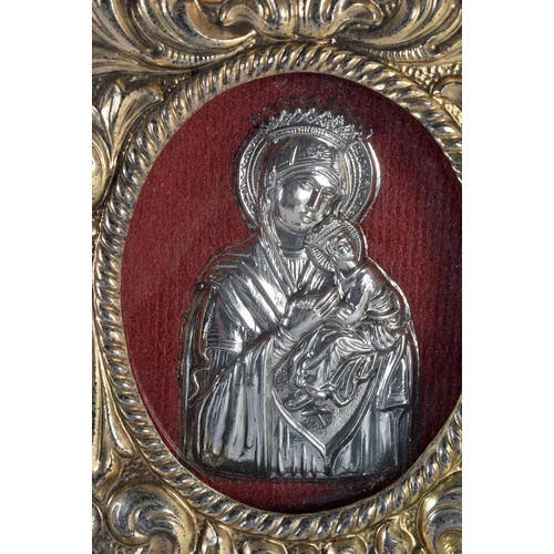 349 - A EUROPEAN YELLOW AND WHITE METAL FRAMED RELIQUARY possibly silver gilt, depicting a Madonna and chi... 