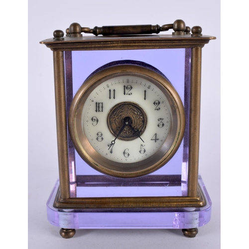 351 - A VERY UNUSUAL EARLY 20TH CENTURY FRENCH BRASS AND AMETHYST GLASS CLOCK with circular enamel dial. 1... 