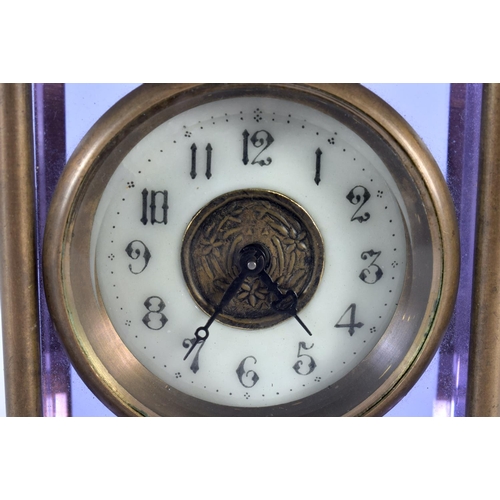 351 - A VERY UNUSUAL EARLY 20TH CENTURY FRENCH BRASS AND AMETHYST GLASS CLOCK with circular enamel dial. 1... 