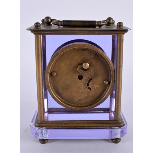 351 - A VERY UNUSUAL EARLY 20TH CENTURY FRENCH BRASS AND AMETHYST GLASS CLOCK with circular enamel dial. 1... 