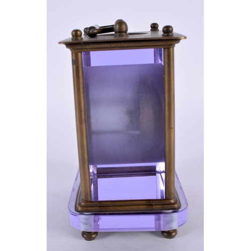 351 - A VERY UNUSUAL EARLY 20TH CENTURY FRENCH BRASS AND AMETHYST GLASS CLOCK with circular enamel dial. 1... 