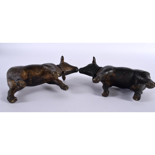 358 - A PAIR OF 18TH/19TH CENTURY INDIAN BRONZE FIGURES OF NANDI BULLS modelled roaming. 11cm x 8 cm.