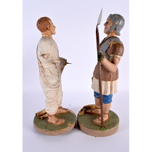 375 - A PAIR OF EARLY 20TH CENTURY CARVED PLASTER OF PARIS FIGURES OF ROMAN SOLDIERS modelled upon circula... 