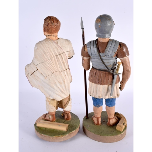 375 - A PAIR OF EARLY 20TH CENTURY CARVED PLASTER OF PARIS FIGURES OF ROMAN SOLDIERS modelled upon circula... 