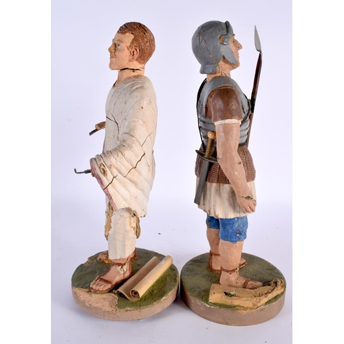 375 - A PAIR OF EARLY 20TH CENTURY CARVED PLASTER OF PARIS FIGURES OF ROMAN SOLDIERS modelled upon circula... 