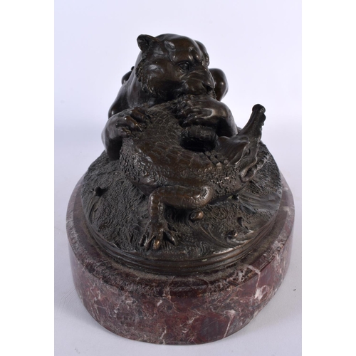 378 - A FRENCH BRONZE AND MARBLE STUDY OF A LEOPARD modelled attacking a crocodile, upon a red marble base... 