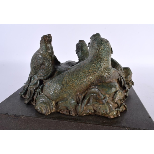 419 - A CHARMING ART DECO GREEN VERDIGRIS BRONZE FIGURE OF SEA LIONS modelled upon crashing waves and a ma... 