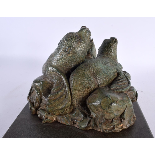 419 - A CHARMING ART DECO GREEN VERDIGRIS BRONZE FIGURE OF SEA LIONS modelled upon crashing waves and a ma... 