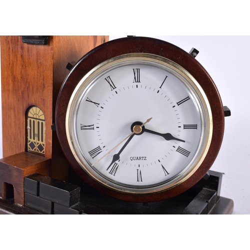 420 - A CHARMING TREEN CARVED WOOD ARCHITECTURAL DESK CLOCK formed as a castle turret. 18cm x 15cm.