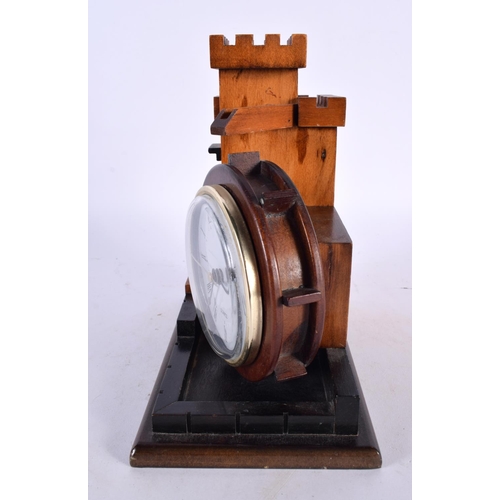 420 - A CHARMING TREEN CARVED WOOD ARCHITECTURAL DESK CLOCK formed as a castle turret. 18cm x 15cm.