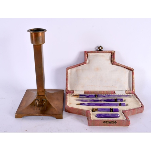 437 - AN ART DECO BAKELITE FIVE PIECE PEN SET together with an Arts and Crafts type brass candlestick. Lar... 