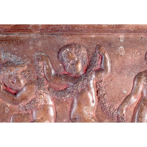 448 - A 19TH CENTURY EUROPEAN CARVED RECTANGULAR TERRACOTTA PANEL depicting four putti in various pursuits... 