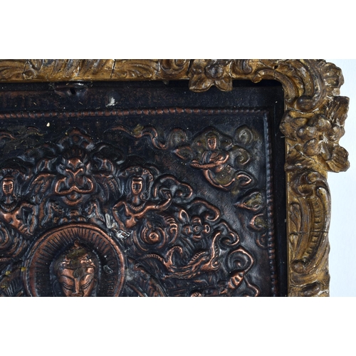 449 - A 19TH CENTURY MIDDLE EASTERN ASIAN REPOUSSE BUDDHISTIC PANEL depicting buddha's, encased within a g... 