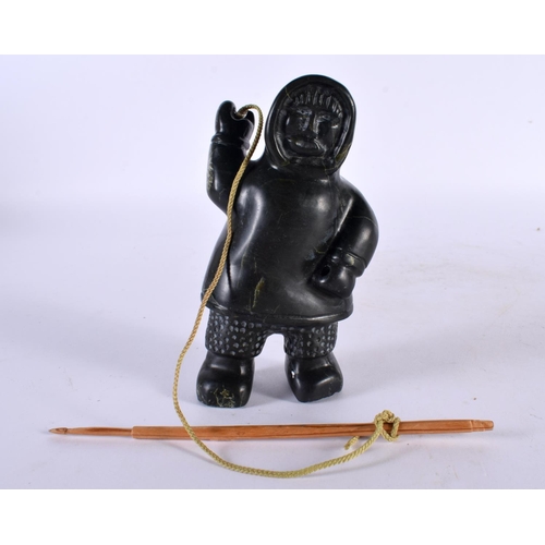 451 - A NORTH AMERICAN CARVED JADE INUIT FIGURE OF AN ESKIMO SEAL HUNTER modelled holding a spear and rope... 