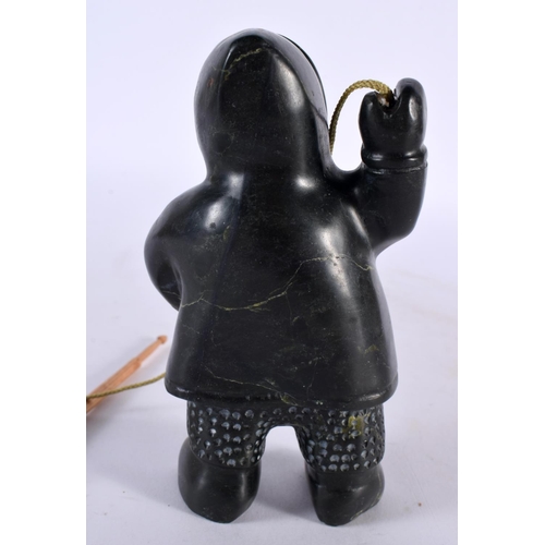 451 - A NORTH AMERICAN CARVED JADE INUIT FIGURE OF AN ESKIMO SEAL HUNTER modelled holding a spear and rope... 