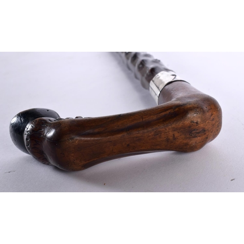 454 - AN UNUSUAL VICTORIAN CARVED WOOD HORSE HOOF WALKING CANE with turned wood knobbled shaft. 85 cm long... 