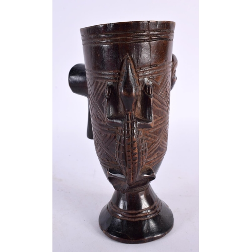 455 - AN AFRICAN ETHIOPIAN COPTIC BRONZE CROSS together with a tribal carved wood cup. Largest 32 cm high.... 