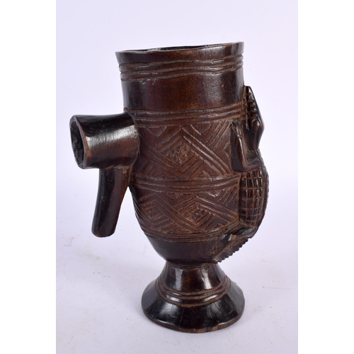 455 - AN AFRICAN ETHIOPIAN COPTIC BRONZE CROSS together with a tribal carved wood cup. Largest 32 cm high.... 