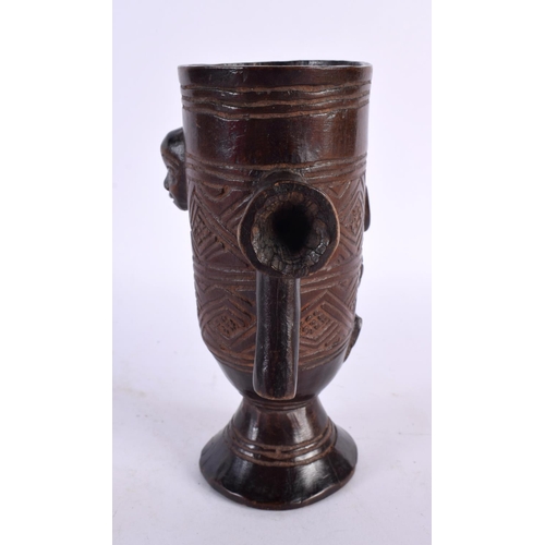 455 - AN AFRICAN ETHIOPIAN COPTIC BRONZE CROSS together with a tribal carved wood cup. Largest 32 cm high.... 